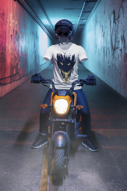 Person sitting on a motorcycle in a dimly lit tunnel with graffiti on the walls while wearing a cool T-shirt from Kim Diaz Holm.